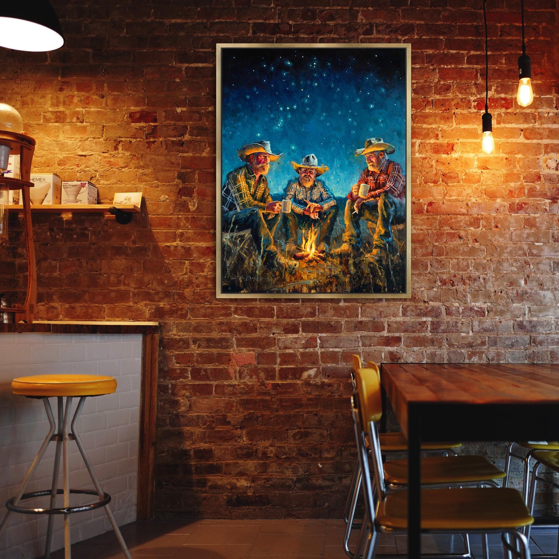 Cowboy art canvas print available in multiple sizes. Cowboys around campfire at night under starry sky. Cowboy wall art print, cowboy print, cowboy decor, western wall art print, western decor. Shown in gold frame.